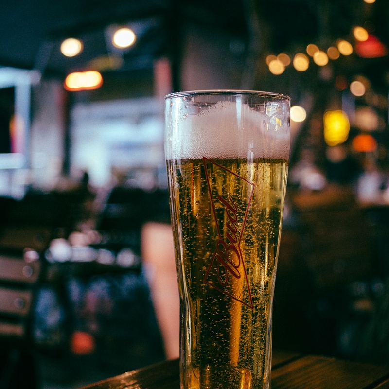Glas bier op een houten tafel in een café
